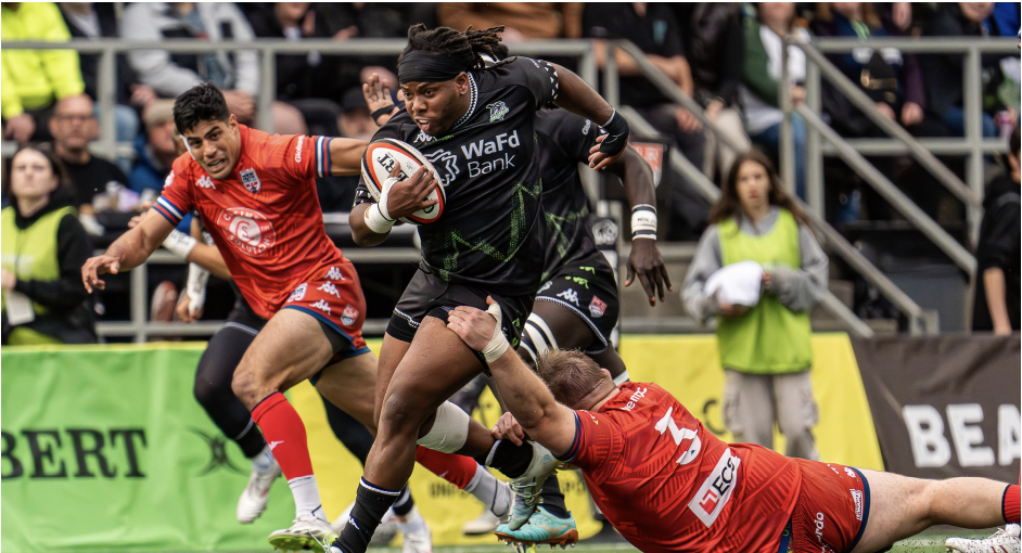 Full speed ahead: 2016 alumnus Daquan Perry dodges a tackle from an Old Glory DC player during a game at Starfire Stadium in May 2024. Perry played for the Seattle Seawolves for their 2024 season and for the New York Ironworkers for their 2023 season.